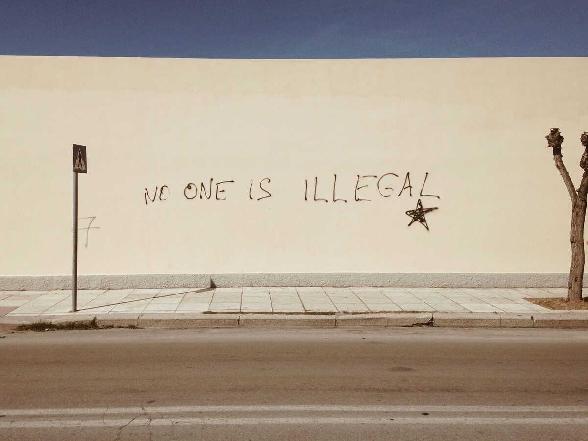 "No one is illegal" painted on well, signifying progressive, inclusive Christian call to welcome immigrants